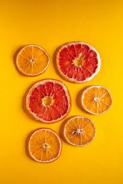 Flat lay composition with dry oranges on orange background Stock Photos