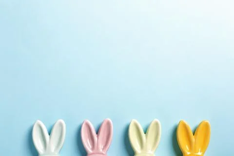 Flat lay composition of Easter bunny ears on color background, space for text Stock Photos
