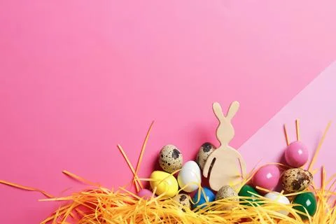 Flat lay composition of Easter bunny figure and eggs on color background, spa Stock Photos