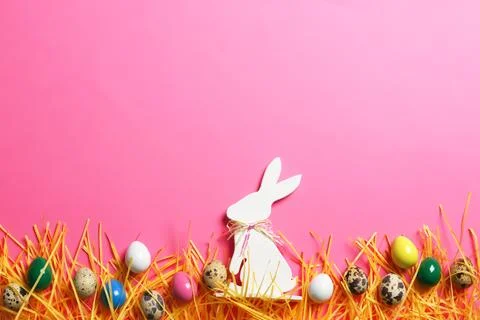 Flat lay composition of Easter bunny figure and eggs on color background, spa Stock Photos
