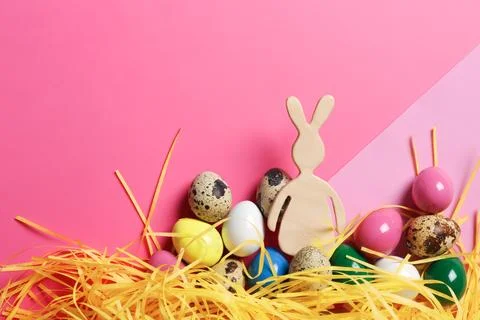 Flat lay composition of Easter bunny figure and eggs on color background, spa Stock Photos