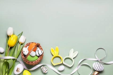 Flat lay composition with Easter eggs in basket and tulip flowers on pale o.. Stock Photos