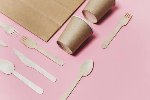 Flat lay composition with eco friendly paper disposable tableware on pink Stock Photos