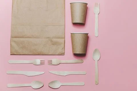 Flat lay composition with eco friendly paper disposable tableware on pink Stock Photos