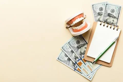Flat lay composition with educational dental typodont model and money with no Stock Photos