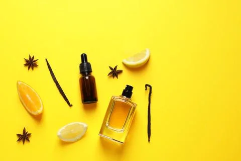 Flat lay composition with elegant perfume on yellow background, space for tex Fotos Stock