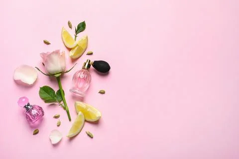 Flat lay composition with elegant perfumes on pink background, space for text Stock-Fotos