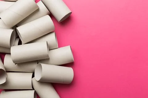 Flat lay composition with empty toilet paper rolls and space for text on colo Stock Photos
