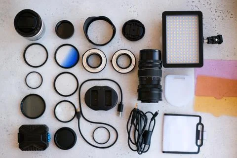 Flat lay composition with equipment for professional photographer on grey bac Stock Photos