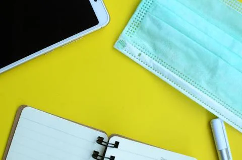 Flat lay composition with face medical masks, cell phones, notebooks, scissors, Foto stock
