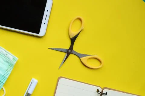 Flat lay composition with face medical masks, cell phones, notebooks, scissors, Stock Photos