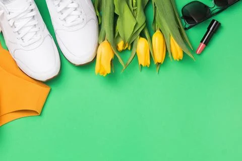 Flat lay composition with feminine accessories and yellow tulips Stock Photos