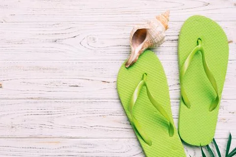 Flat lay composition with flip flops and seashell on colored background. Sp.. Stock Photos
