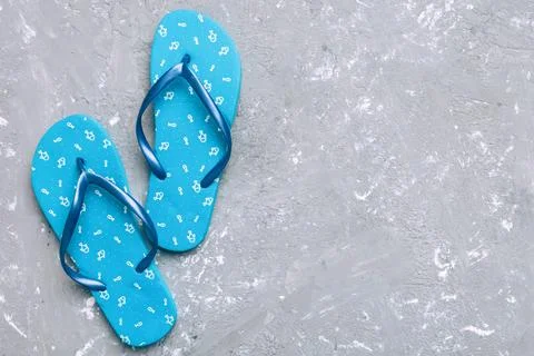 Flat lay composition with flip flops and seashell on colored background. Spac Stock Photos