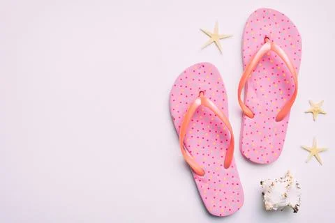Flat lay composition with flip flops and seashell on colored background. Sp.. Stock Photos