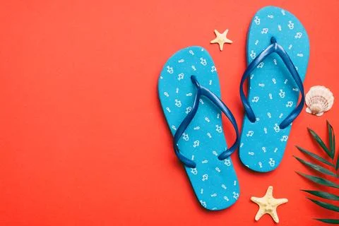 Flat lay composition with flip flops and seashell on colored background. Sp.. Stock Photos