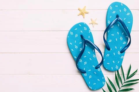 Flat lay composition with flip flops and seashell on colored background. Sp.. Stock Photos