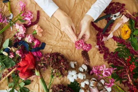 Flat lay composition florist creates a bouquet on craft paper Stock Photos