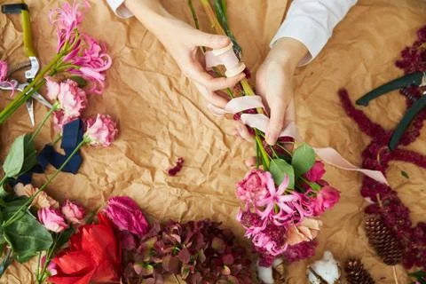Flat lay composition florist creates a bouquet on craft paper Stock Photos