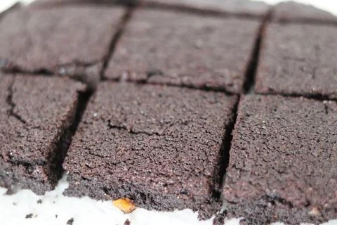 Flat lay composition with fresh brownies on parchment paper. Stock Photos