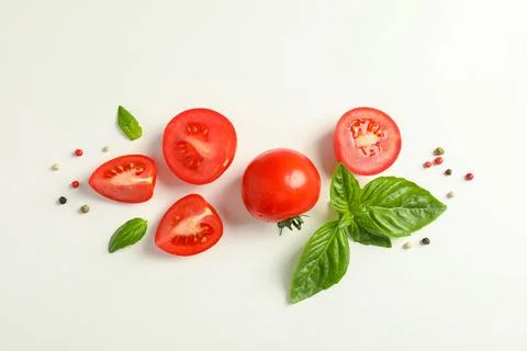 Flat lay composition with fresh cherry tomatoes, pepper and basil on white .. Stock Photos