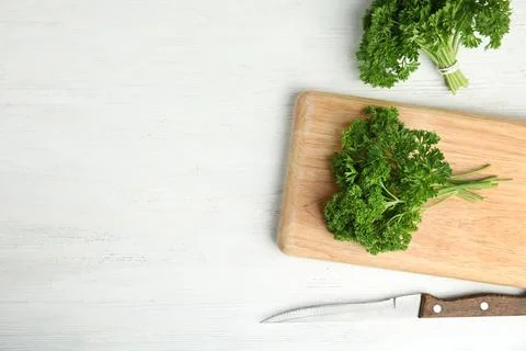 Flat lay composition with fresh green parsley on wooden table, space for text Stock Photos