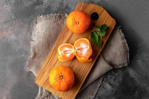 Flat lay composition with fresh orange tangerines on a wooden cutting board a Stock Photos