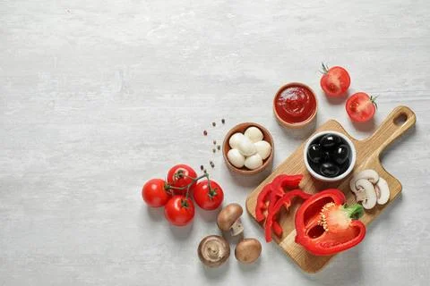 Flat lay composition with fresh pizza  ingredients on white wooden table. Spa Stock Photos