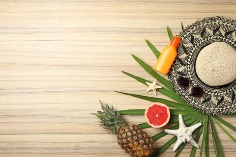 Flat lay composition with fruits and beach objects on wooden background. Spac Stock Photos