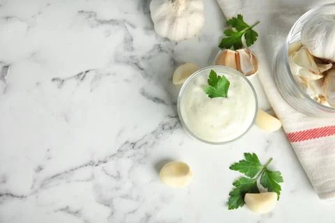 Flat lay composition with garlic sauce on marble background. Space for text Stock Photos