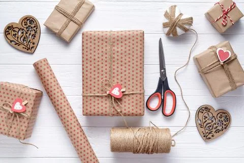 Flat lay composition with gift, scissors, wrapping paper and twine. Packaging of Stock Photos