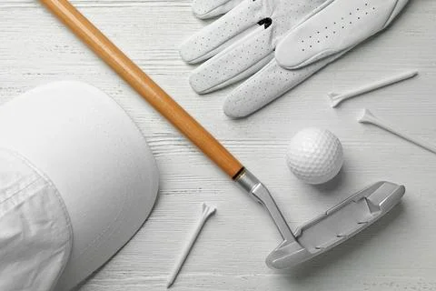 Flat lay composition with golf accessories on white wooden background Stock Photos