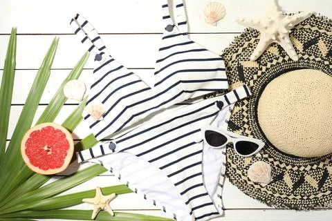 Flat lay composition with grapefruit and beach objects on white wooden backgr Stock Photos