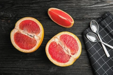 Flat lay composition with grapefruits on dark wooden background 스톡 사진
