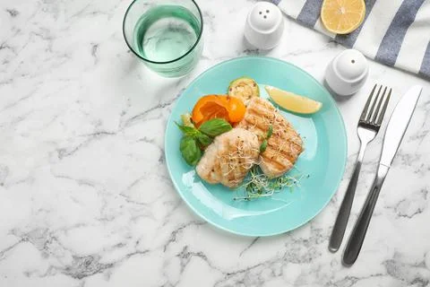 Flat lay composition with grilled fish on marble table Stock Photos