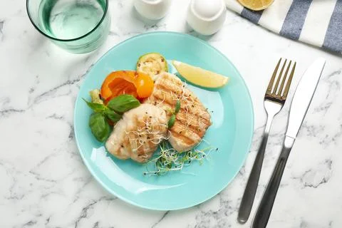 Flat lay composition with grilled fish on marble table Stock Photos