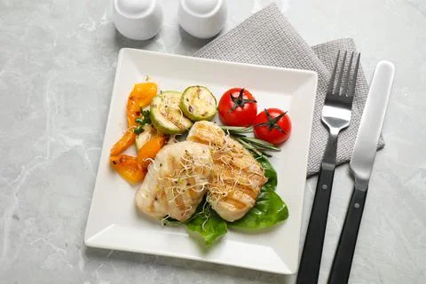 Flat lay composition with grilled fish on light grey marble table Stock Photos