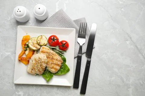 Flat lay composition with grilled fish on light grey marble table Stock Photos