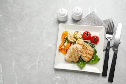 Flat lay composition with grilled fish on light grey marble table. Space for  Stock Photos
