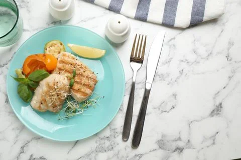 Flat lay composition with grilled fish on marble table Stock Photos