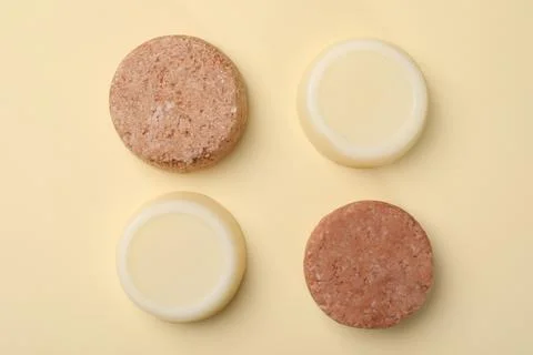 Flat lay composition with group of solid shampoo bars on beige background. Ha 写真素材