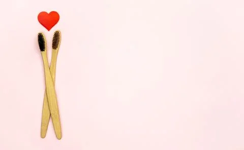 Flat lay composition with heart shape with bamboo toothbrushes and space for Stock Photos