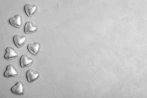 Flat lay composition with heart shaped candies and space for text on grey bac Stock Photos