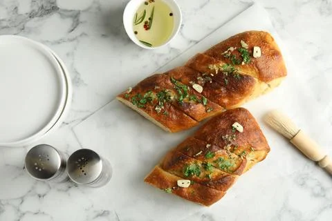 Flat lay composition with homemade garlic bread on table Stock Photos