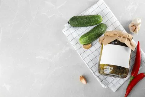 Flat lay composition with jar of pickled cucumbers on light table, space for  Stock Photos