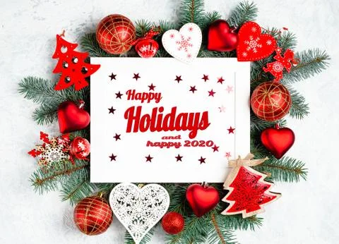 Flat lay composition with the lettering, happy holidays and happy 2020. Frame Photos