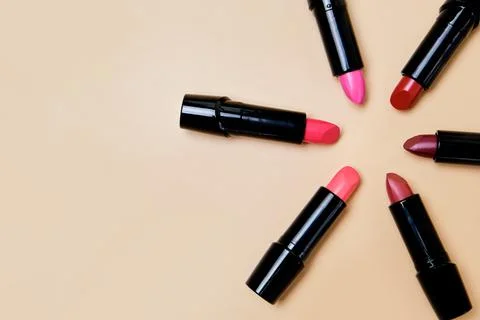Flat lay composition with lipsticks and space for text on color background Stock Photos