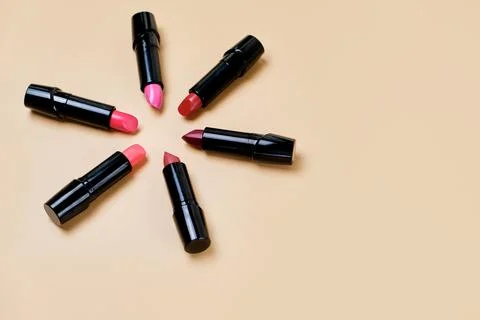 Flat lay composition with lipsticks and space for text on color background Stock Photos