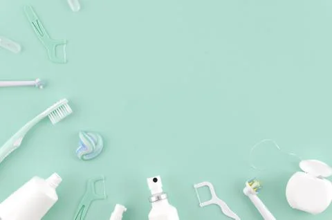 Flat lay composition with manual toothbrushes and oral hygiene products on mint Stock Photos