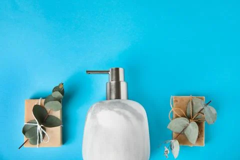Flat lay composition with marble soap dispenser on light blue background. Spa 스톡 사진